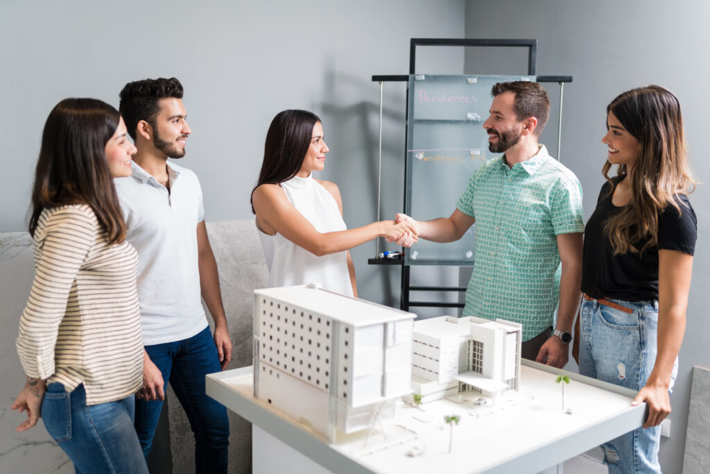 architects greeting partners for new construction projects at office