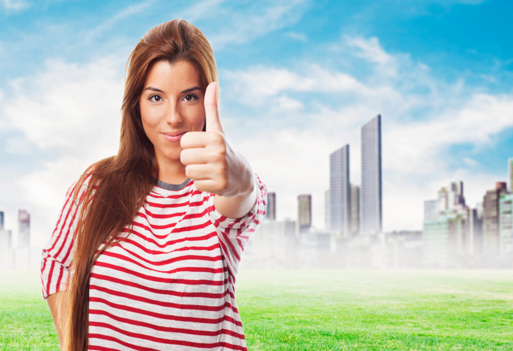 a pretty young woman with thumb up
